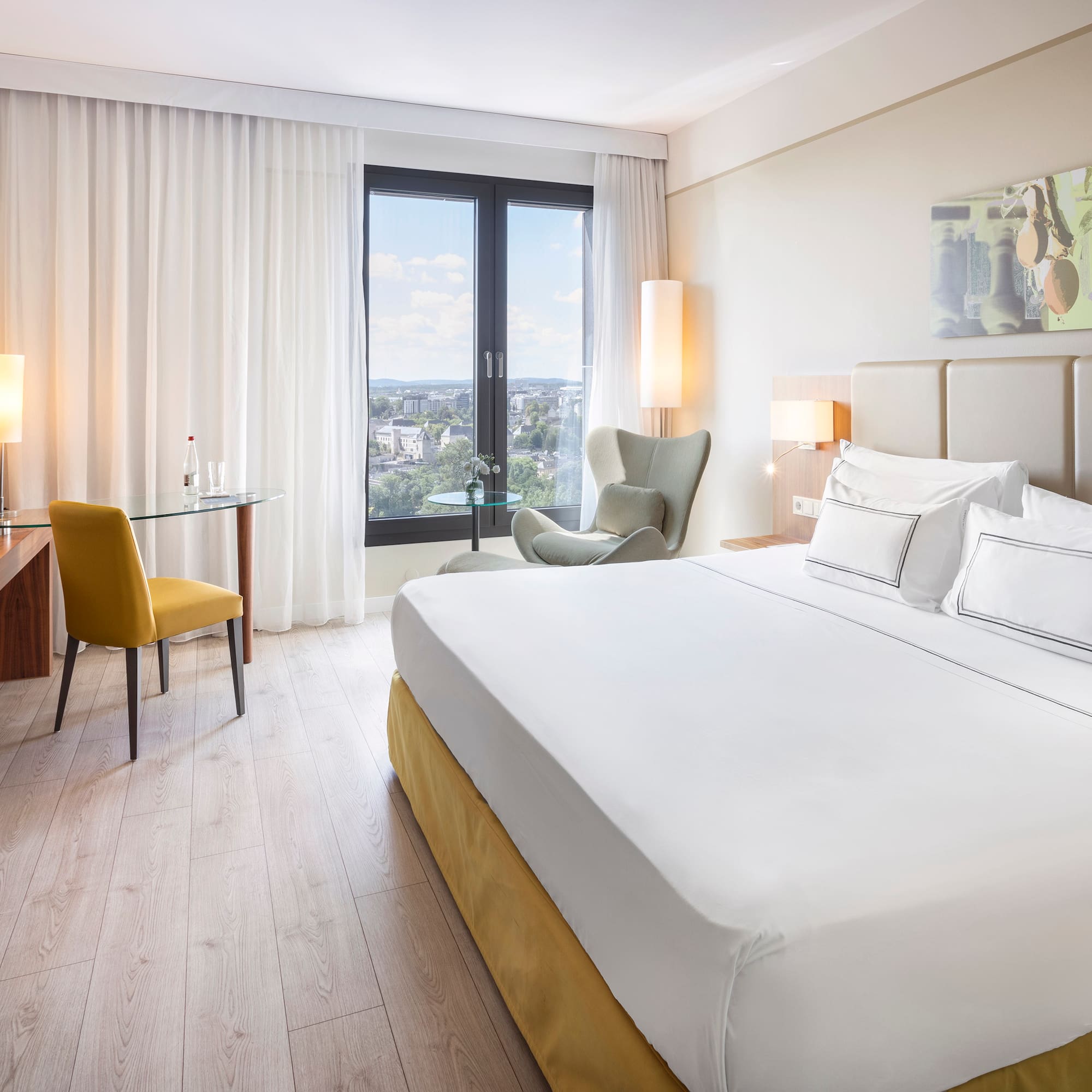 a room with a bed and a desk and chair