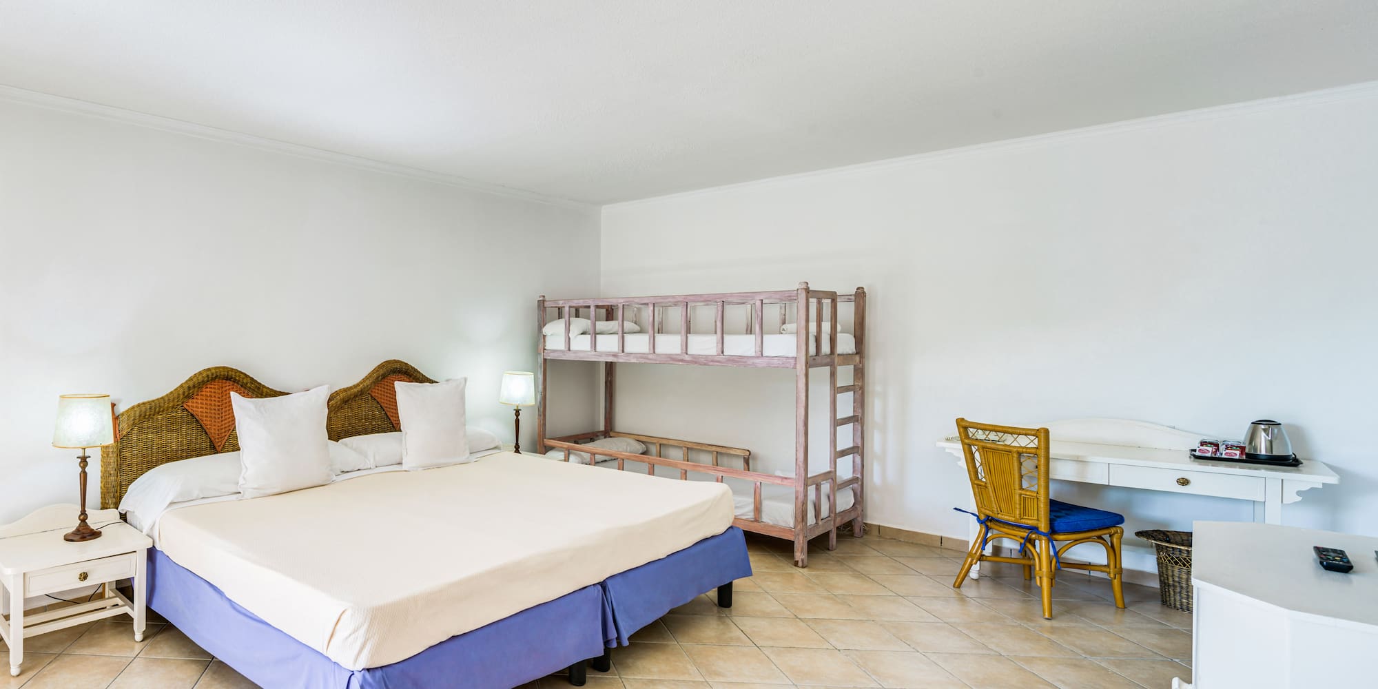 a room with a bed and bunk beds