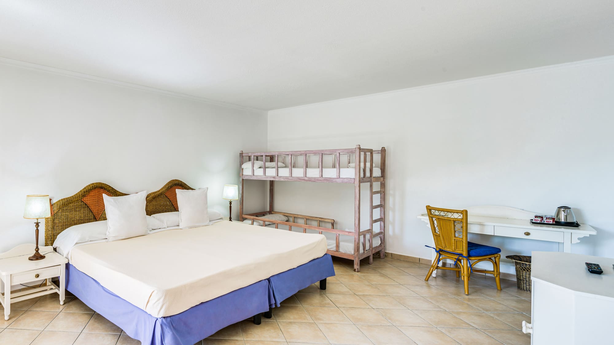 a room with a bed and bunk beds