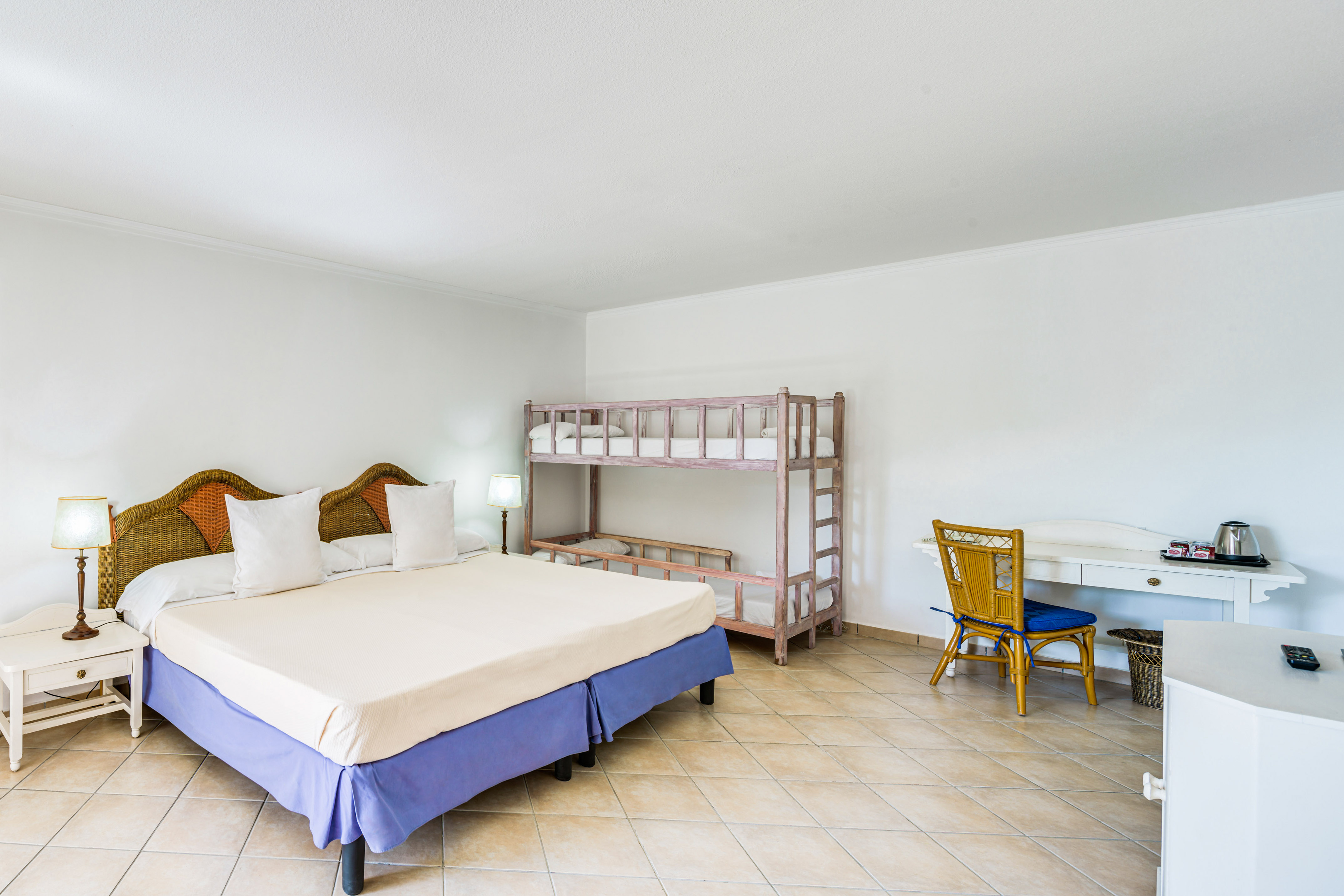 a room with a bed and bunk beds