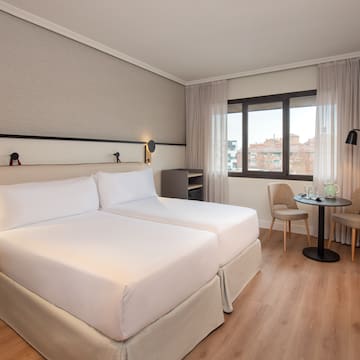 a room with two beds and a table
