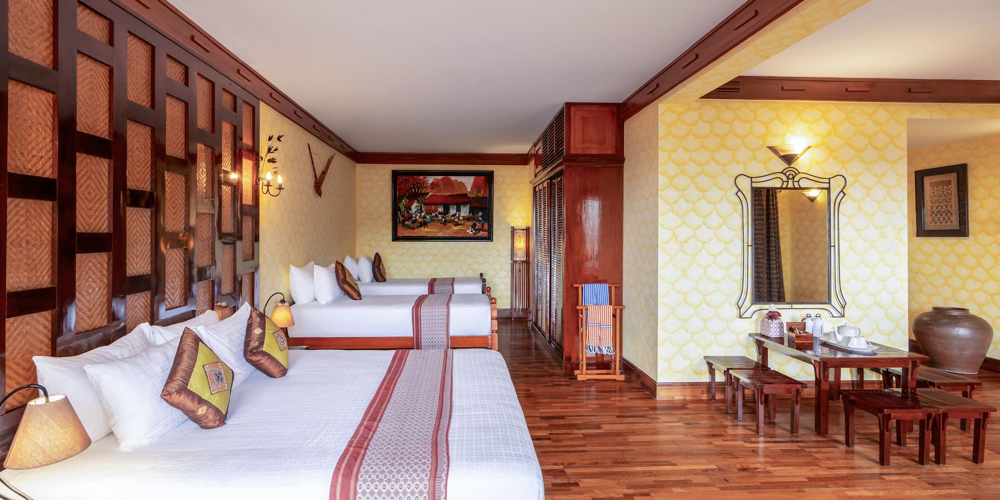 a room with two beds and a mirror