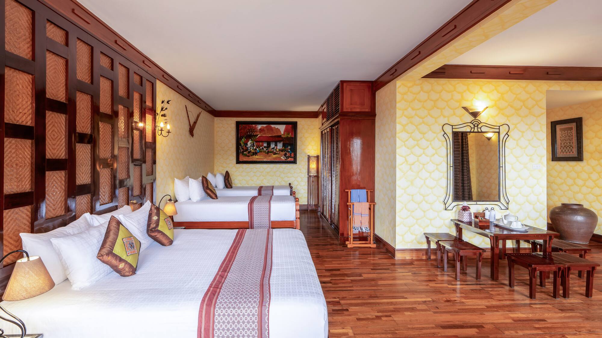 a room with two beds and a mirror