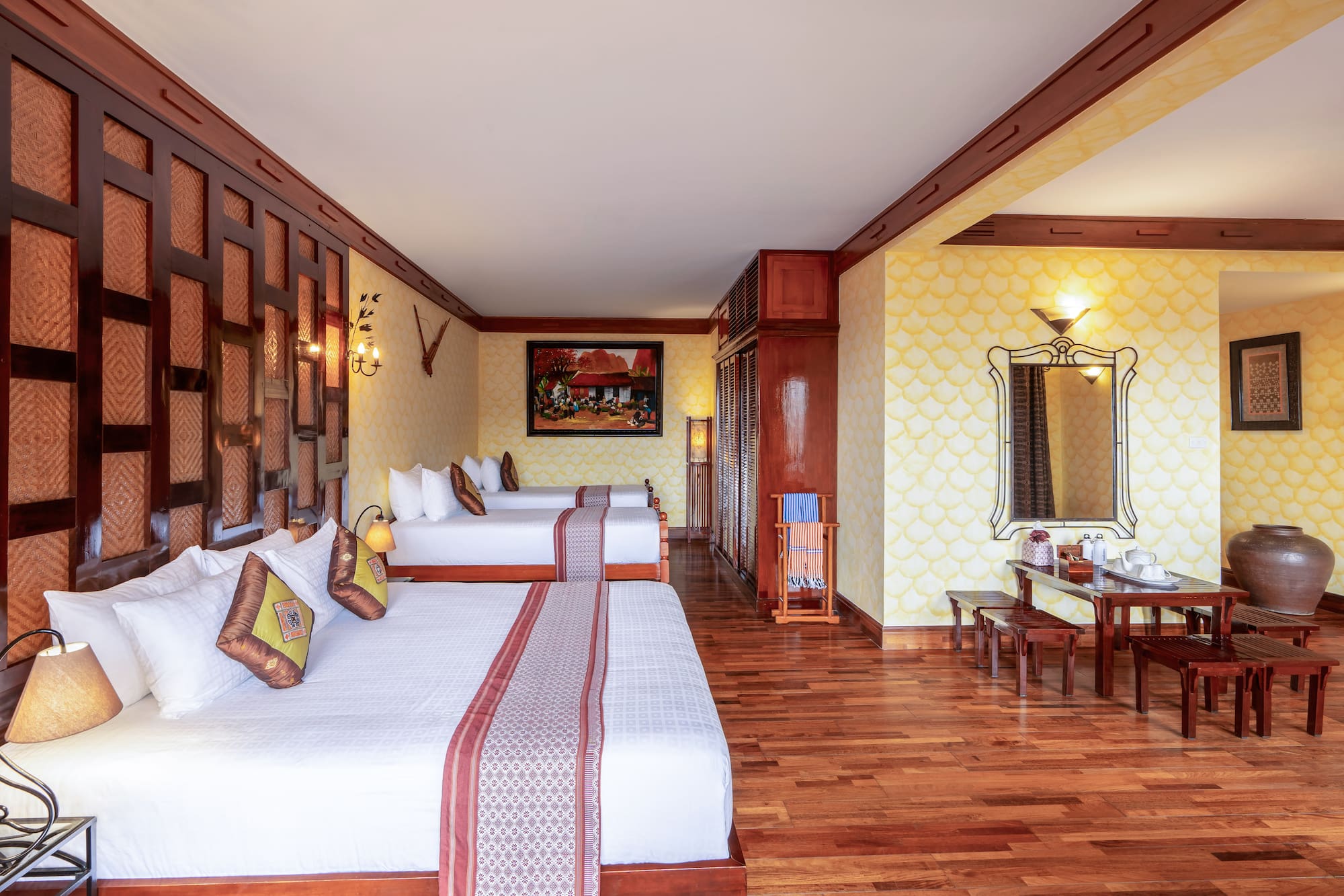 a room with two beds and a mirror