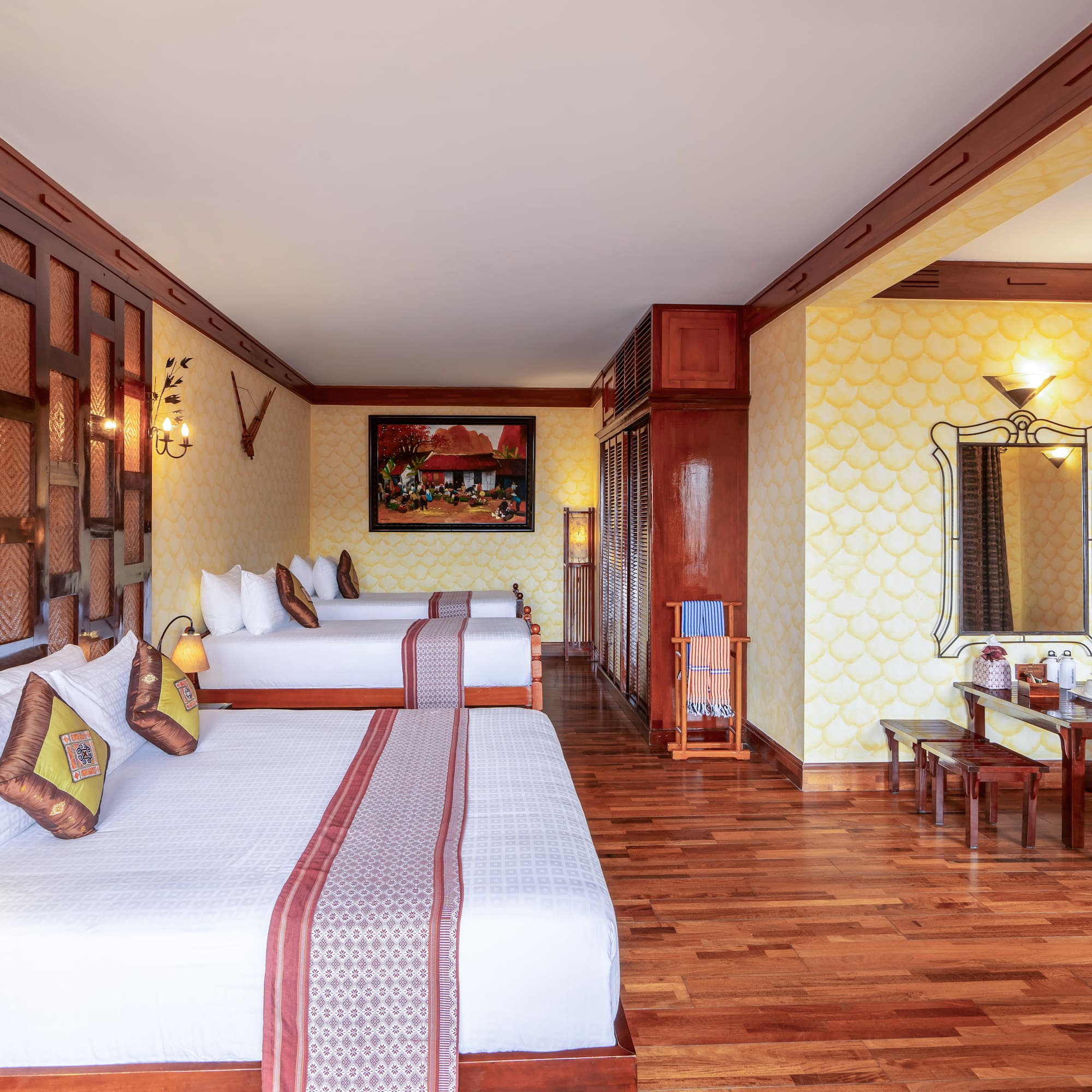 a room with two beds and a mirror