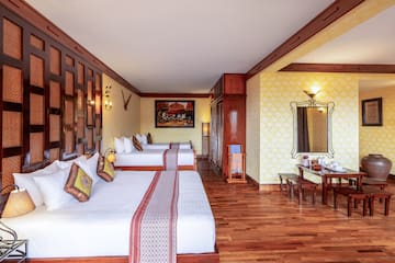 a room with two beds and a mirror