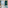 Hotel room with sea view balcony, sandy beach, and modern teal decor.