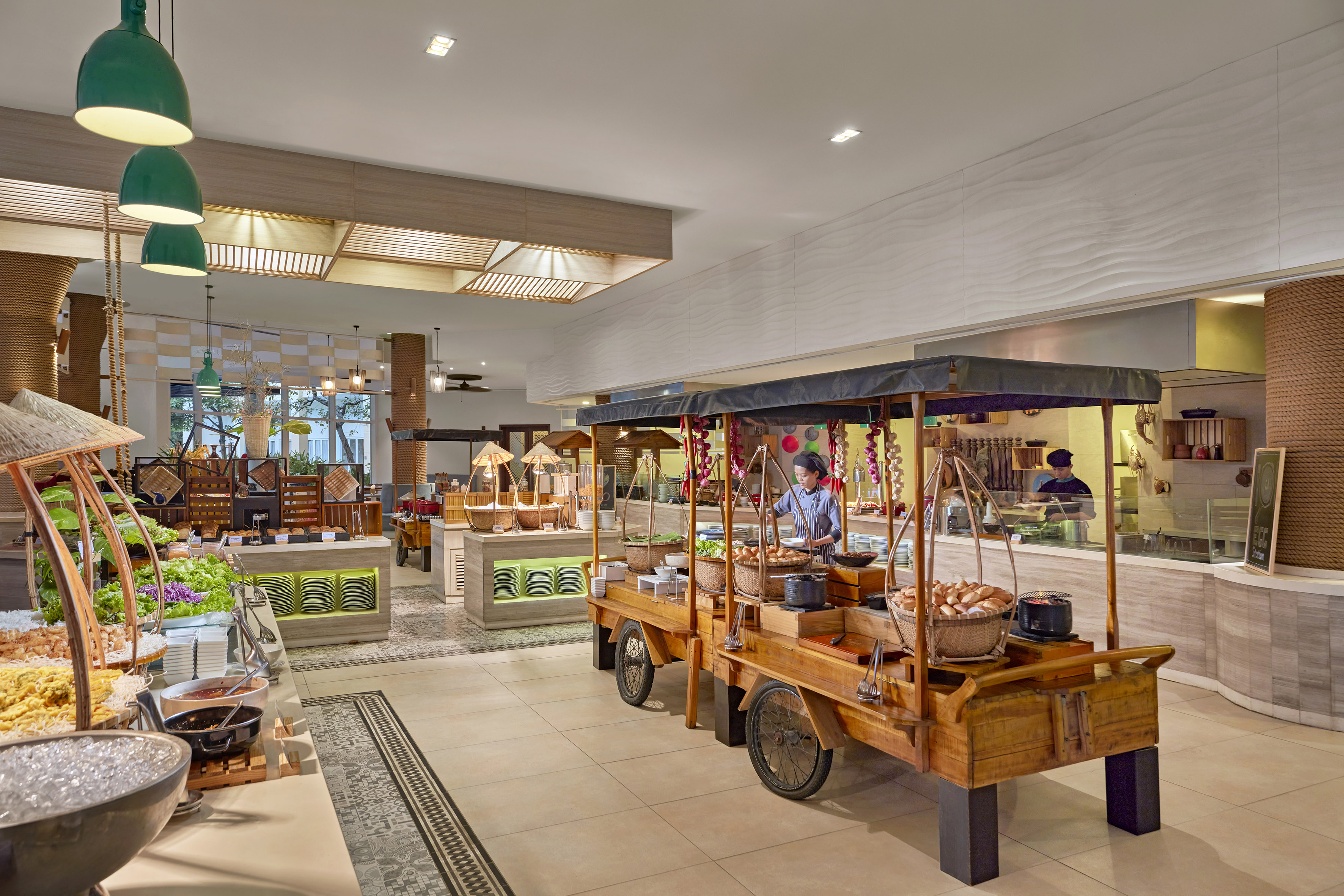 Asian buffet restaurant with chef at live cooking station and food carts.