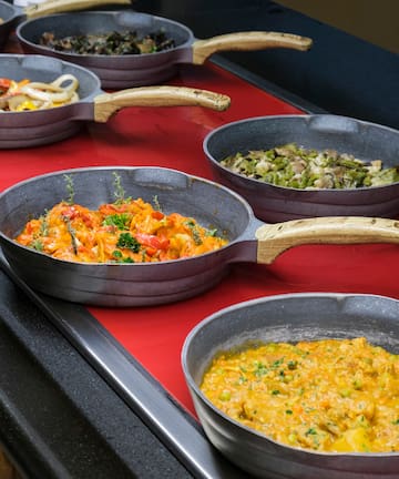 a row of pans with food in them