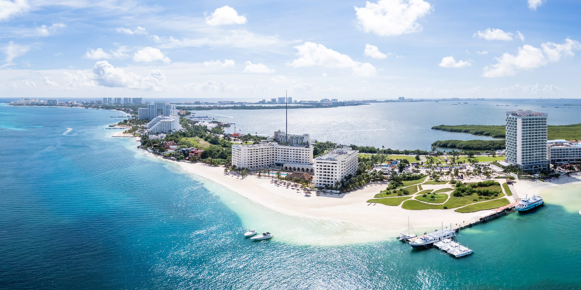 a beach with buildings and boats in the water