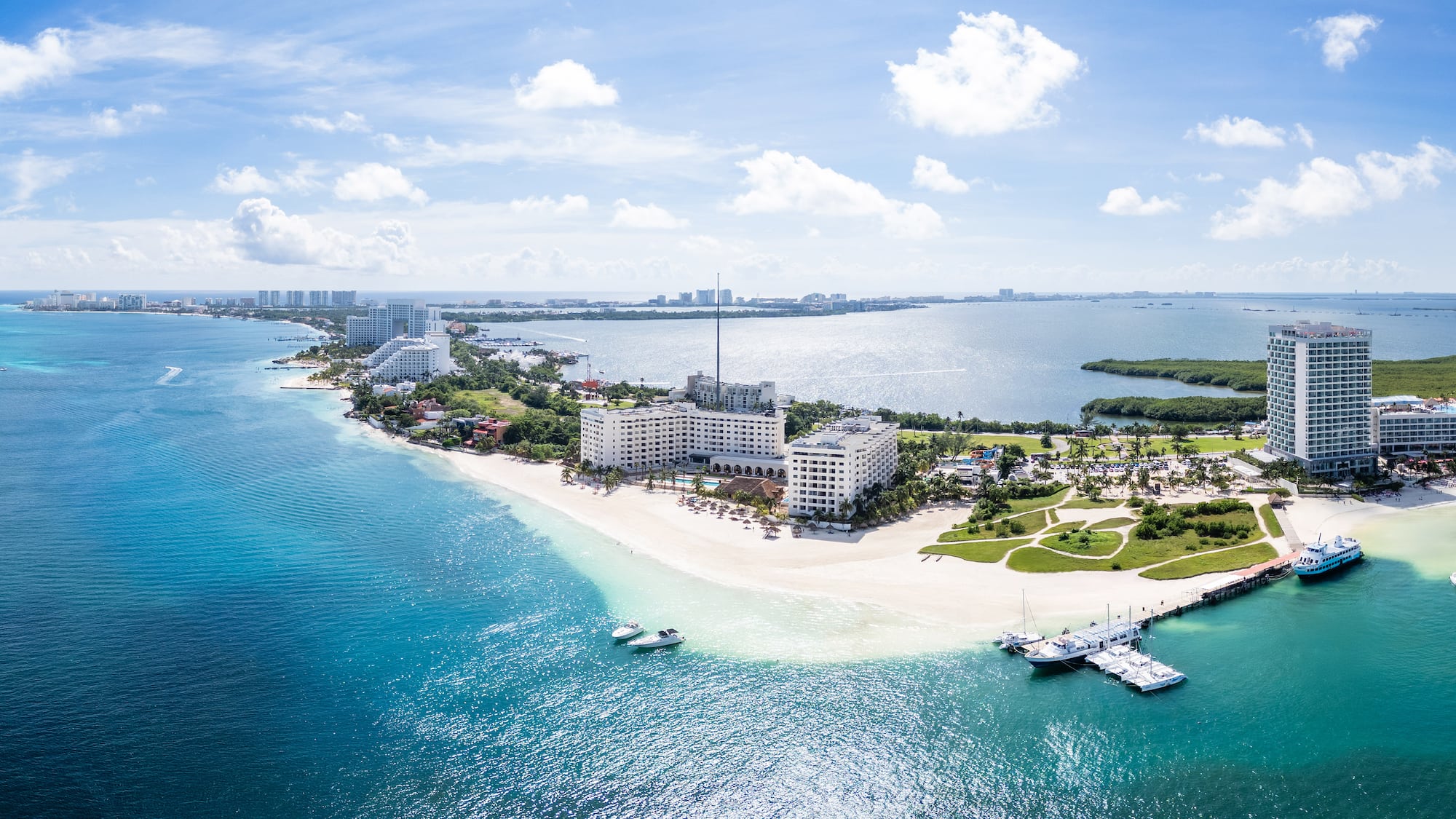 a beach with buildings and boats in the water