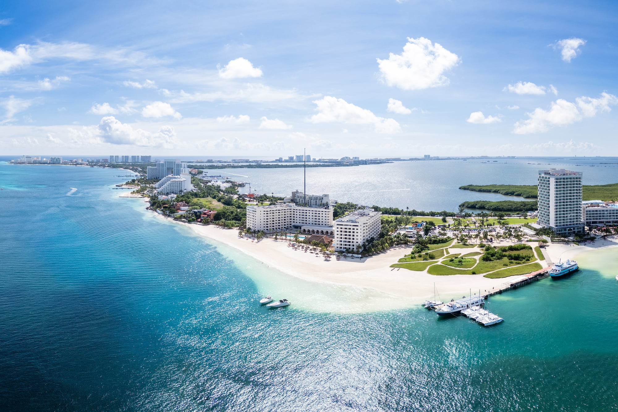 a beach with buildings and boats in the water
