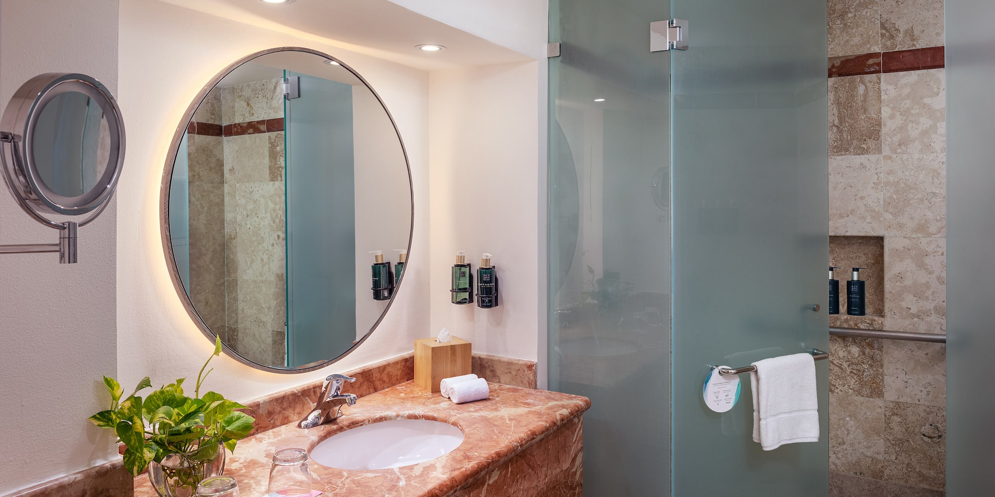 a bathroom with a mirror and a shower
