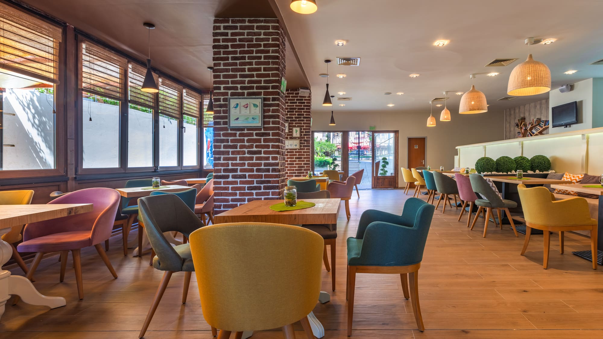 a room with a brick wall and chairs