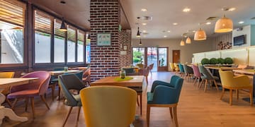 a room with a brick wall and chairs