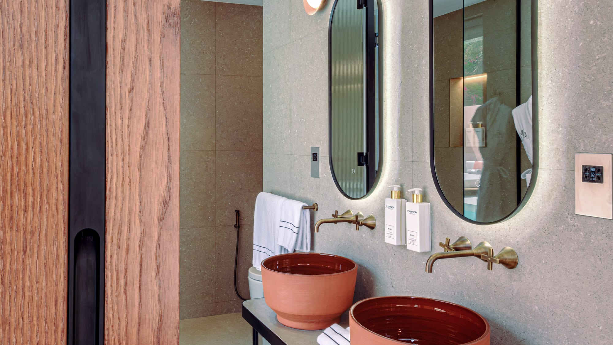 a bathroom with two sinks and mirrors