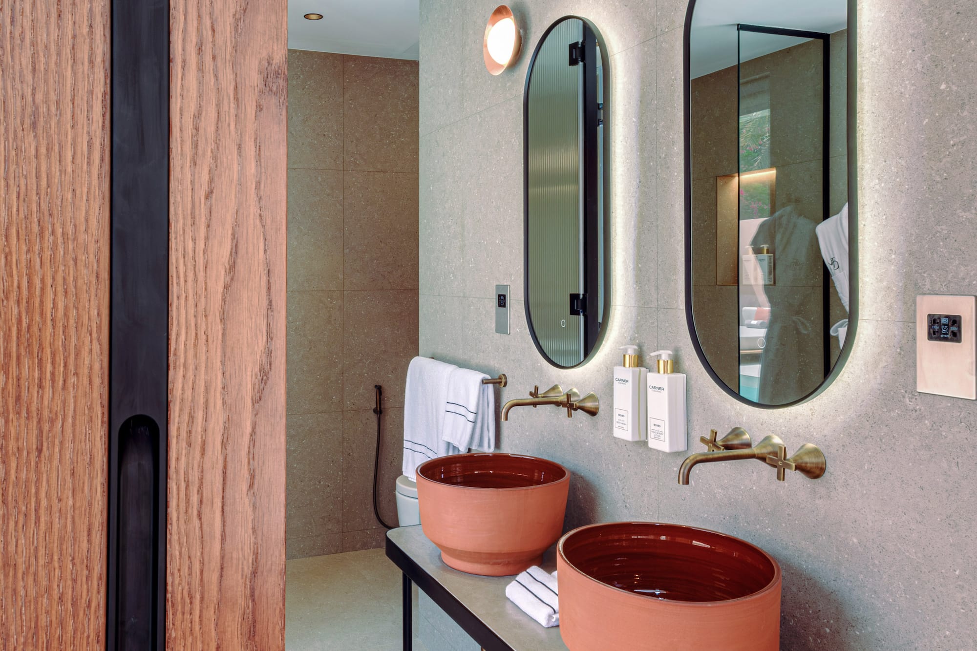 a bathroom with two sinks and mirrors