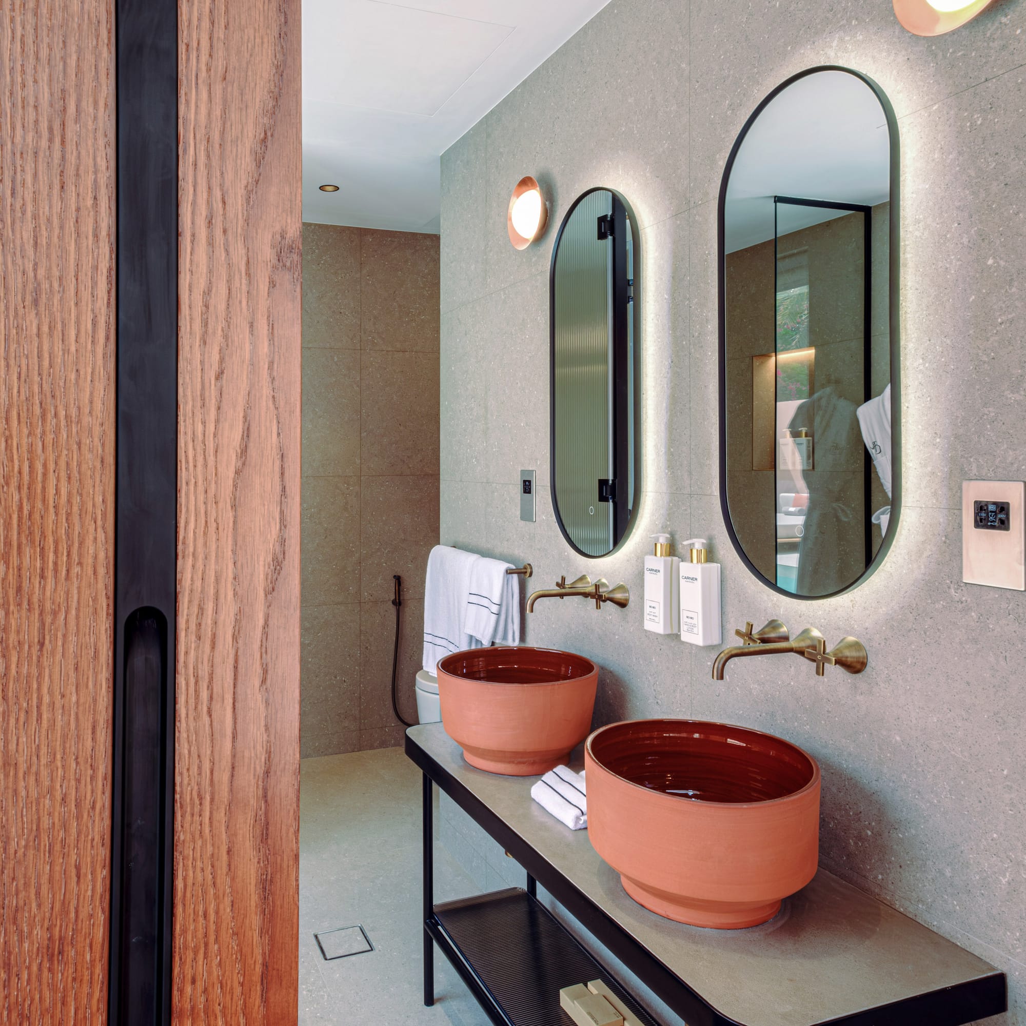 a bathroom with two sinks and mirrors