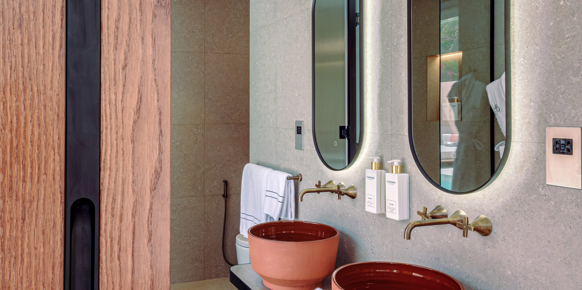 a bathroom with two sinks and mirrors