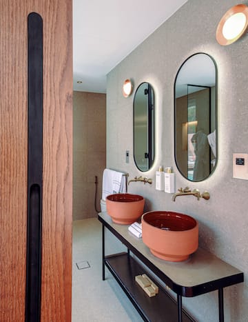 a bathroom with two sinks and mirrors