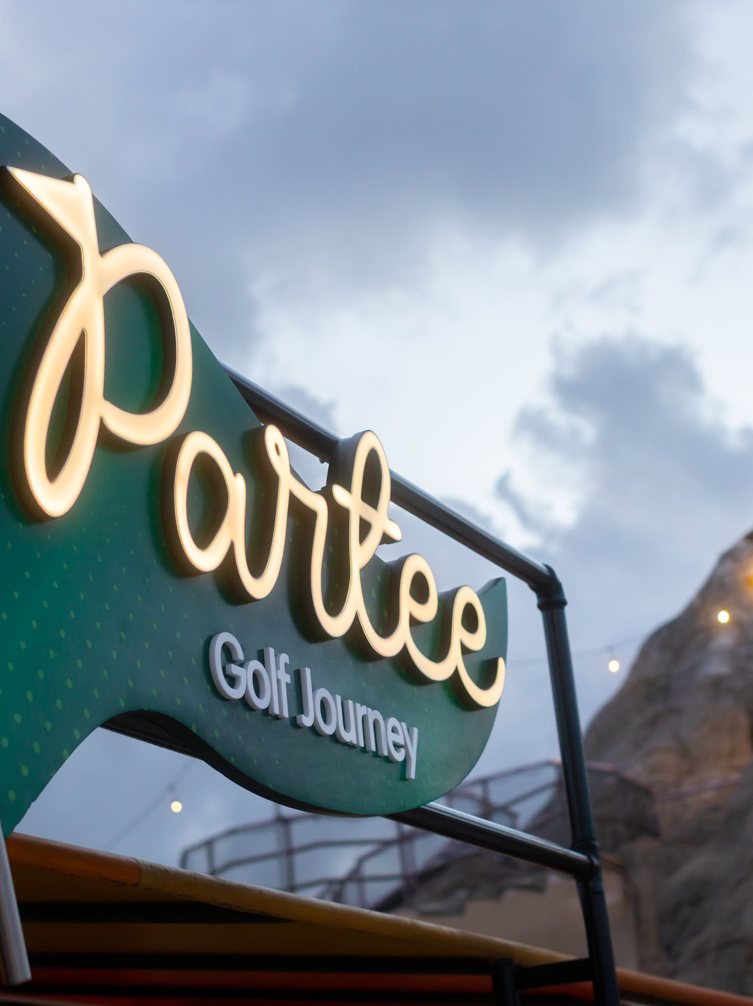 a sign with a mountain in the background