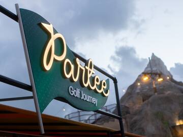 a sign with a mountain in the background