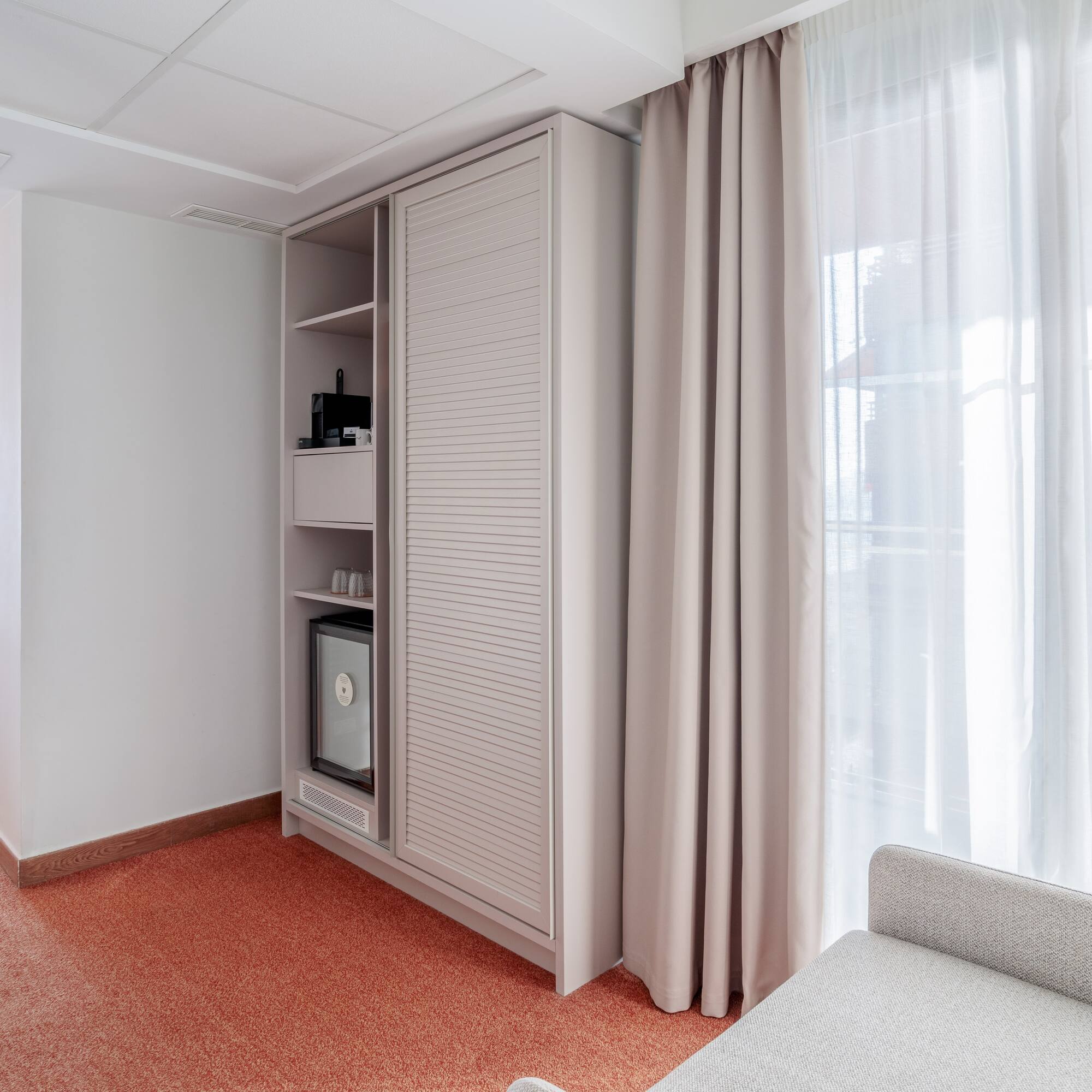 a room with a couch and a cabinet