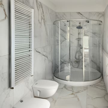 a bathroom with a glass shower and toilet