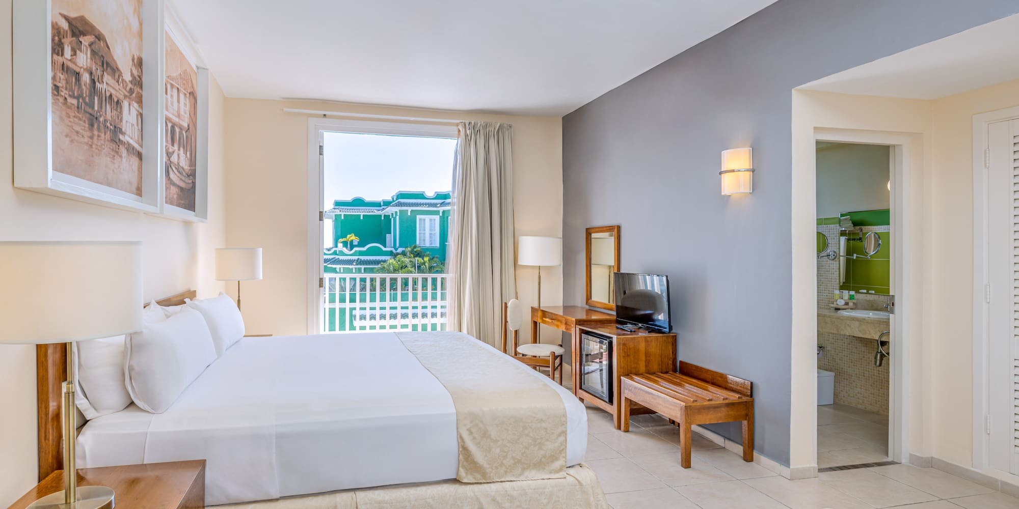 a room with a bed and a television