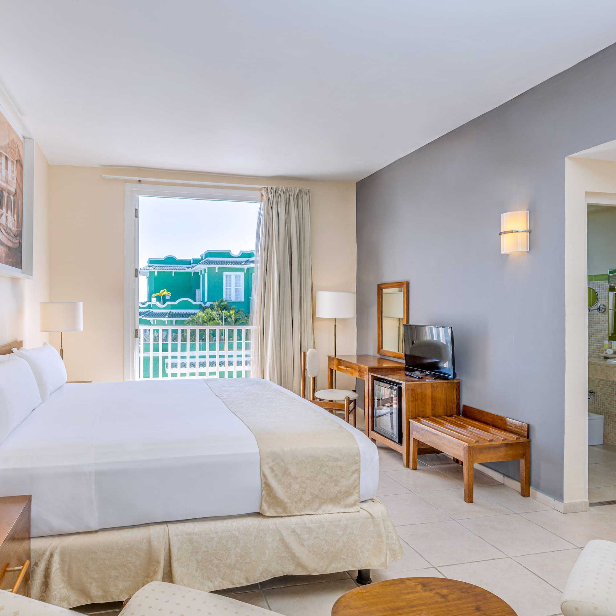 a room with a bed and a television