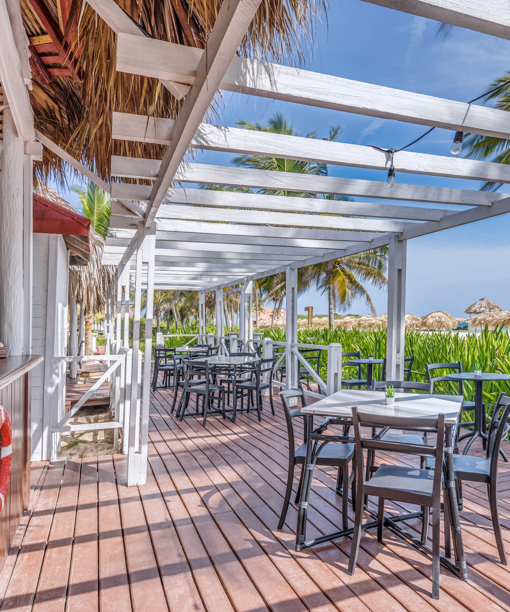 a wooden deck with tables and chairs on it