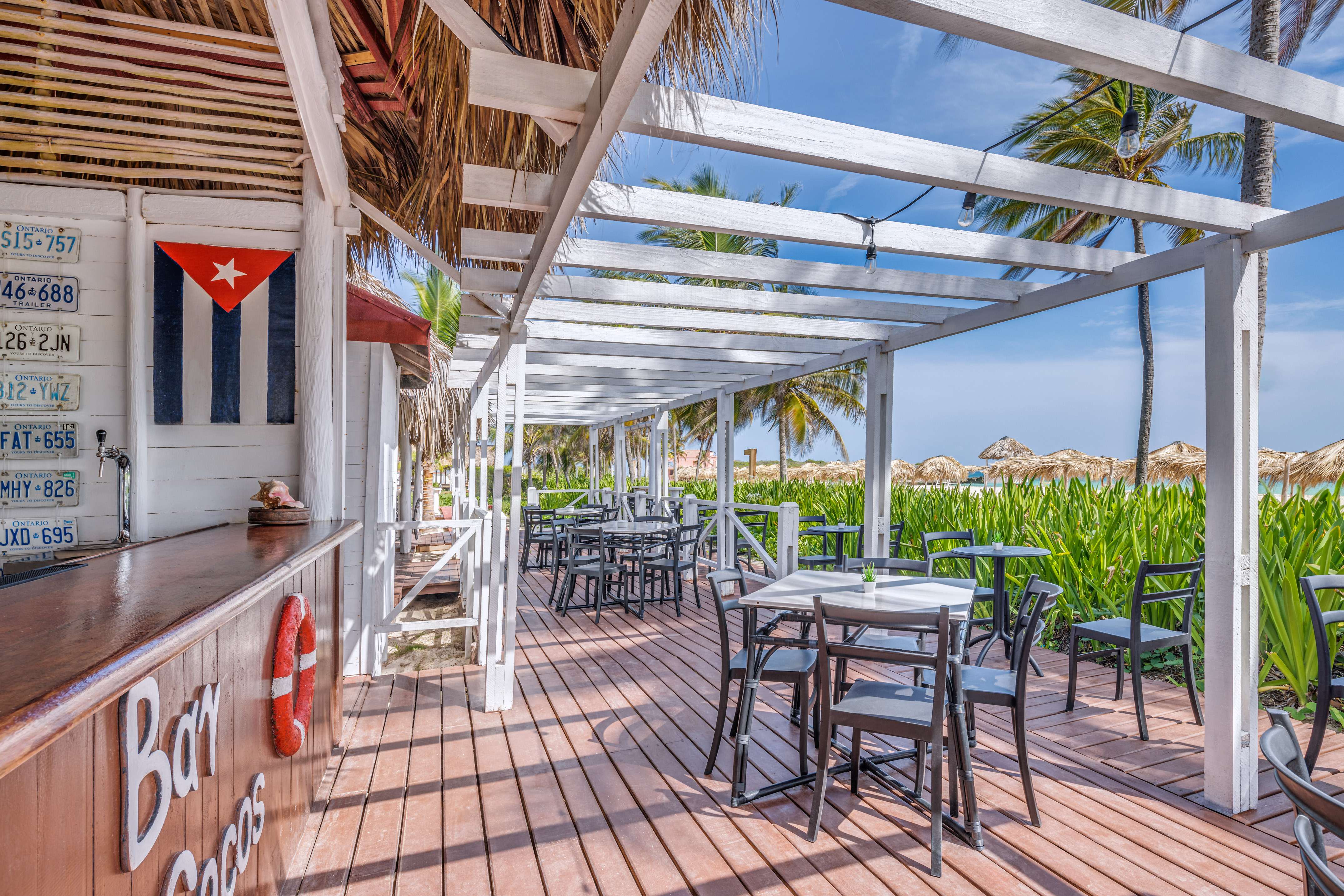 a wooden deck with tables and chairs on it