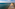 a beach with umbrellas and chairs and a body of water