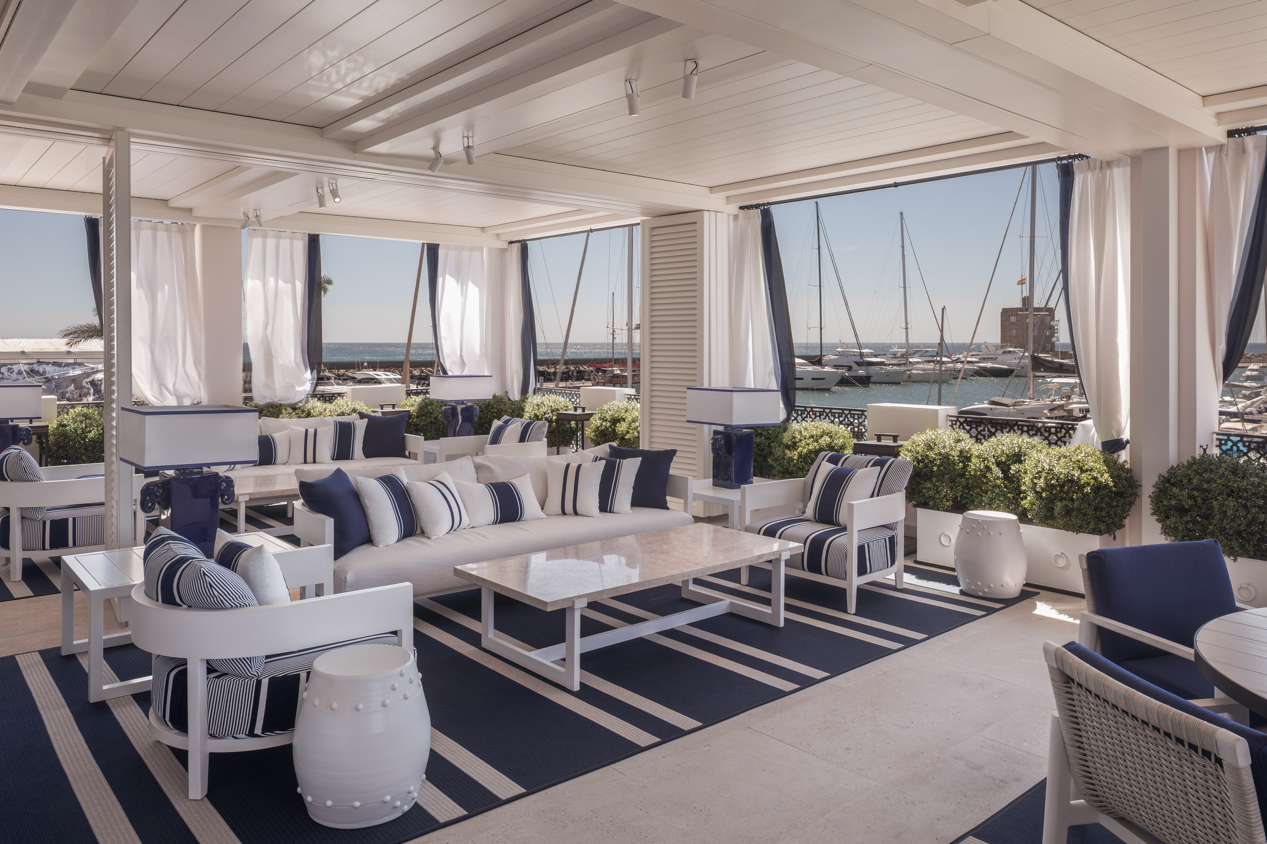 a room with a large window and a view of the water