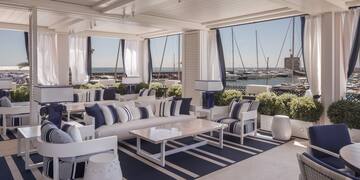 a room with a large window and a view of the water