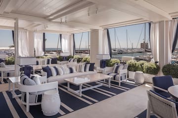 a room with a large window and a view of the water