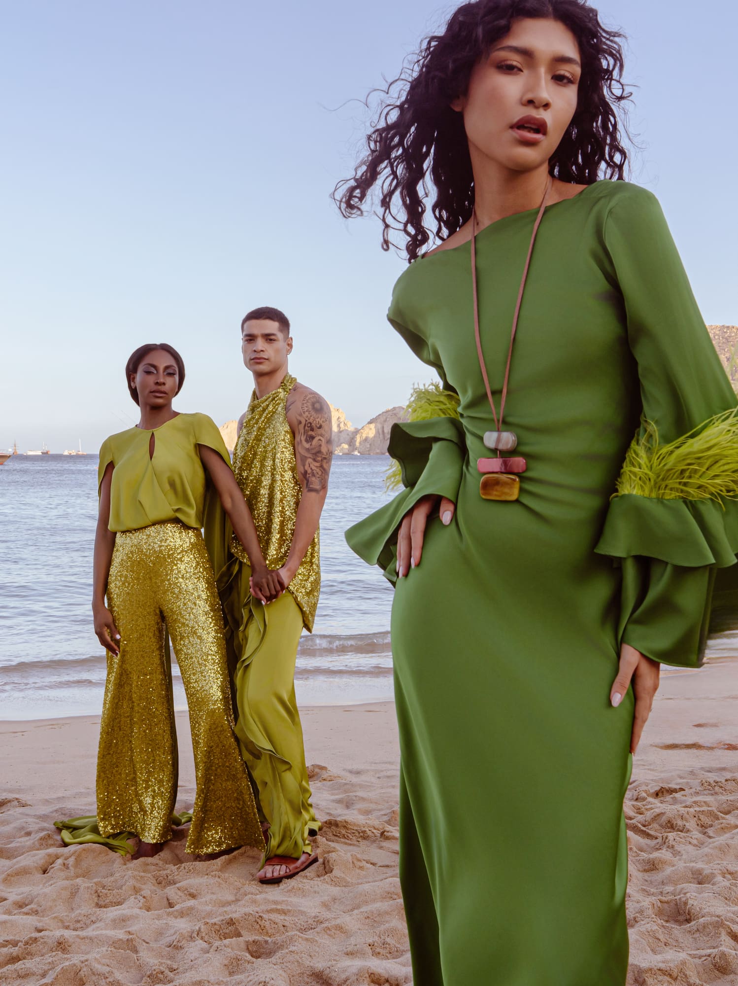 a group of people posing for a picture on a beach