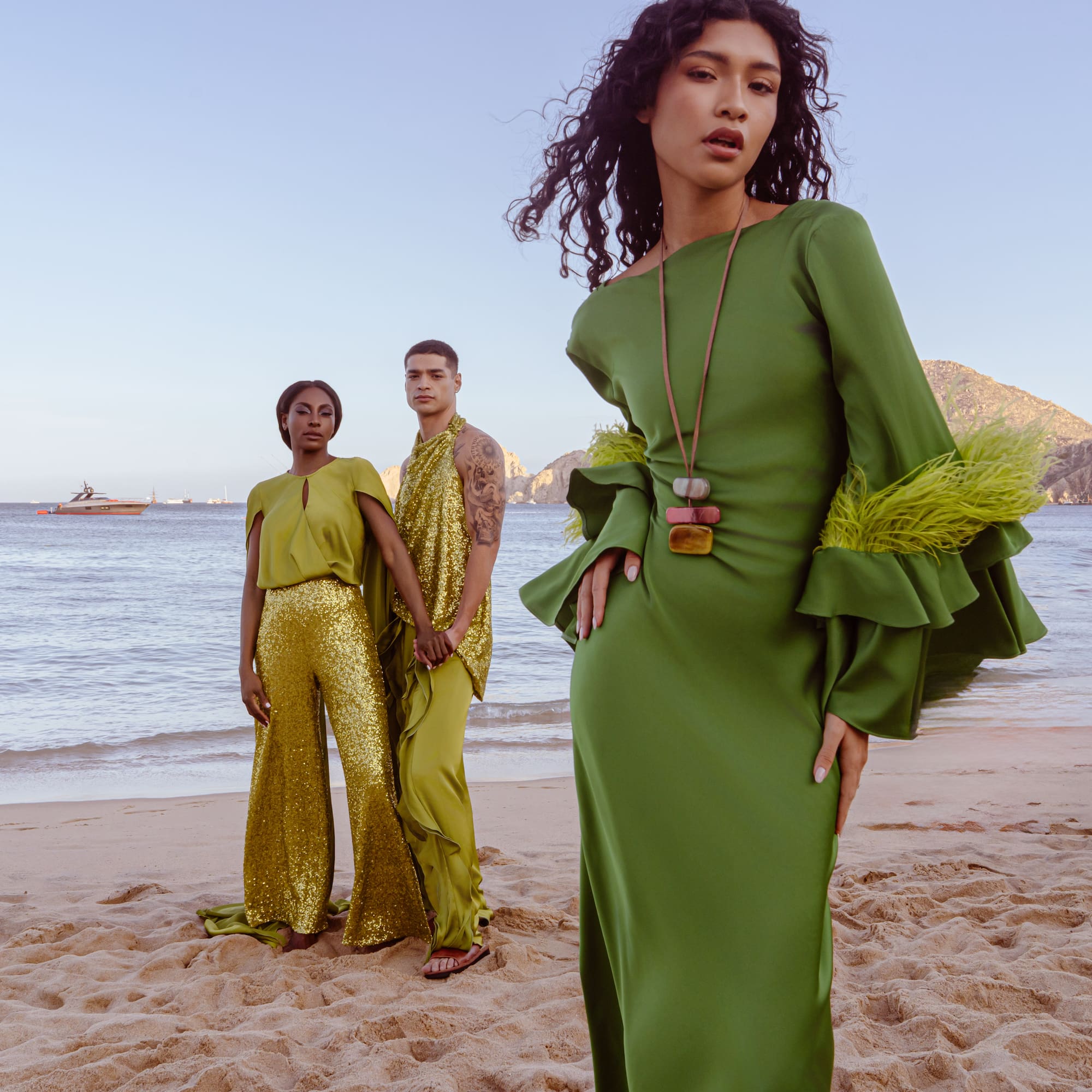 a group of people posing for a picture on a beach