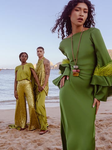 a group of people posing for a picture on a beach