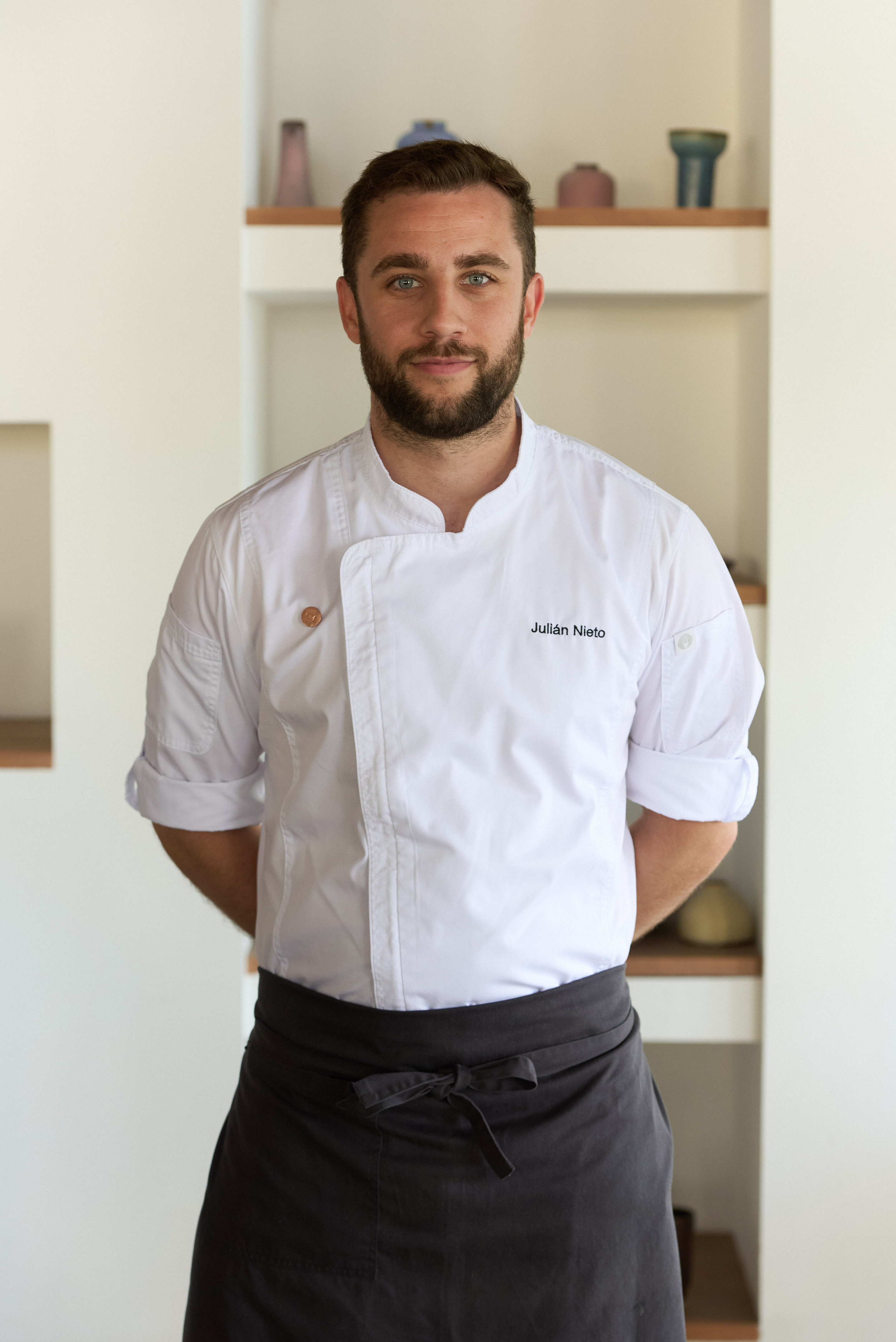 Julián Nieto, professional chef, in white uniform and dark apron.