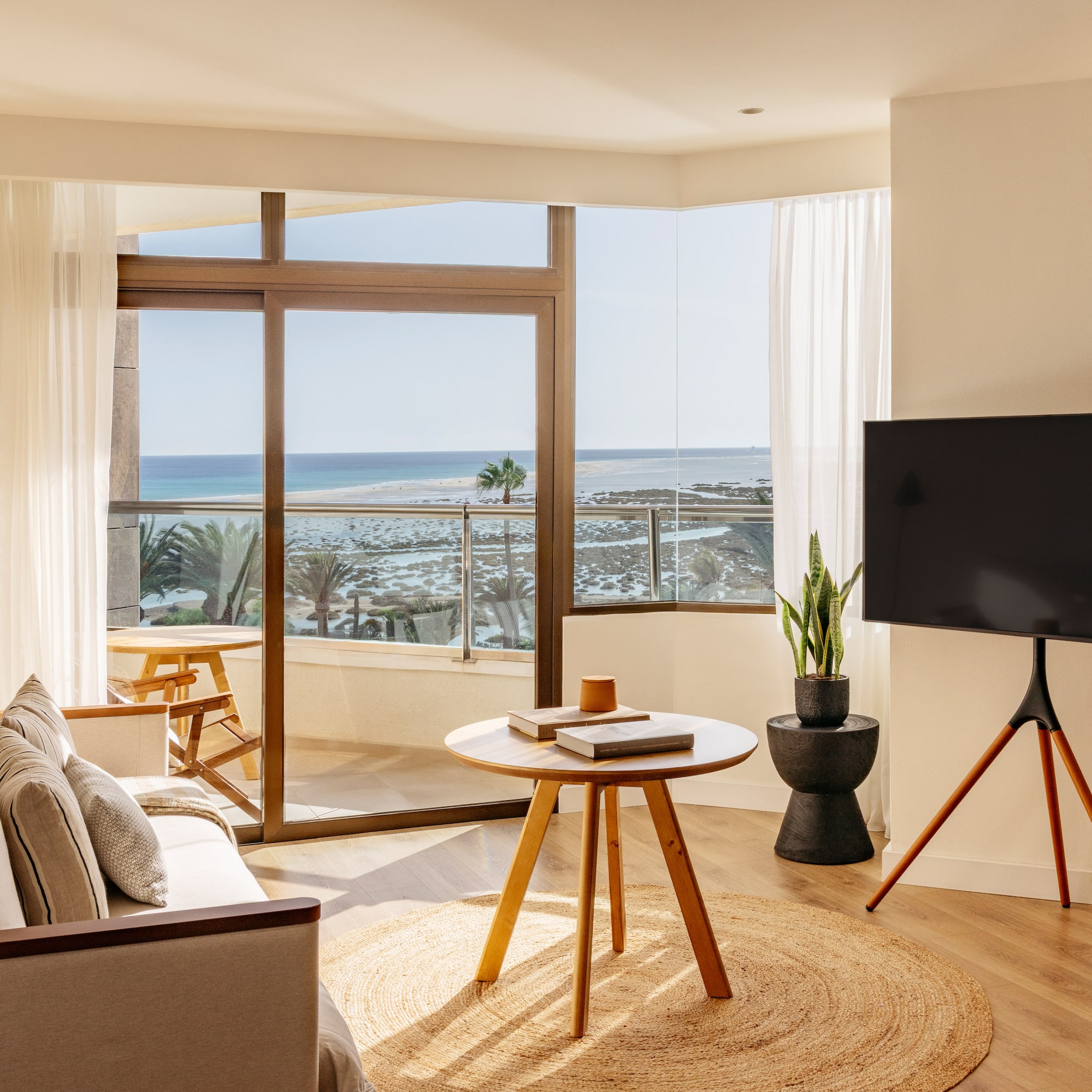 a living room with a television and a table