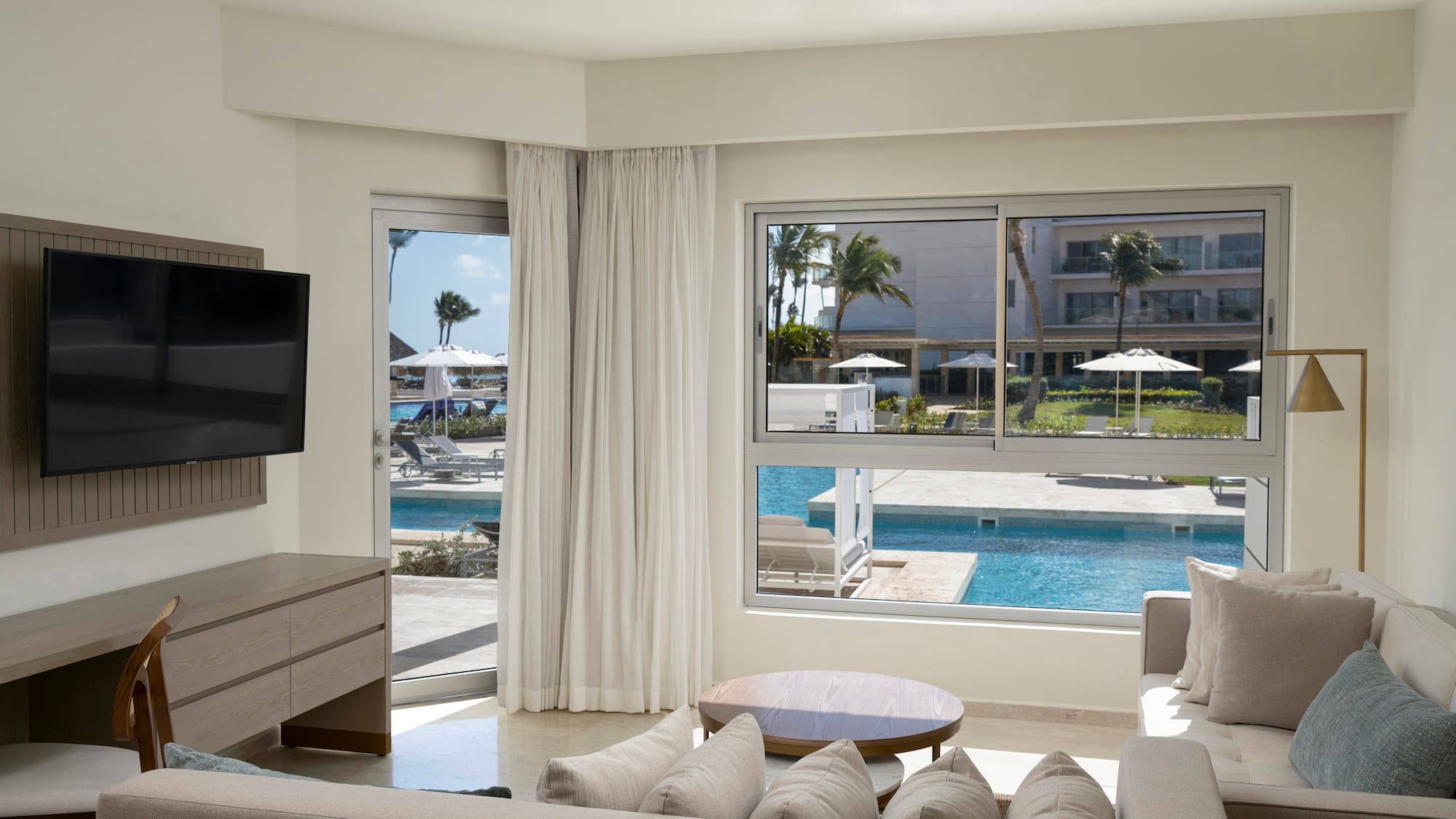 a living room with a television and a pool