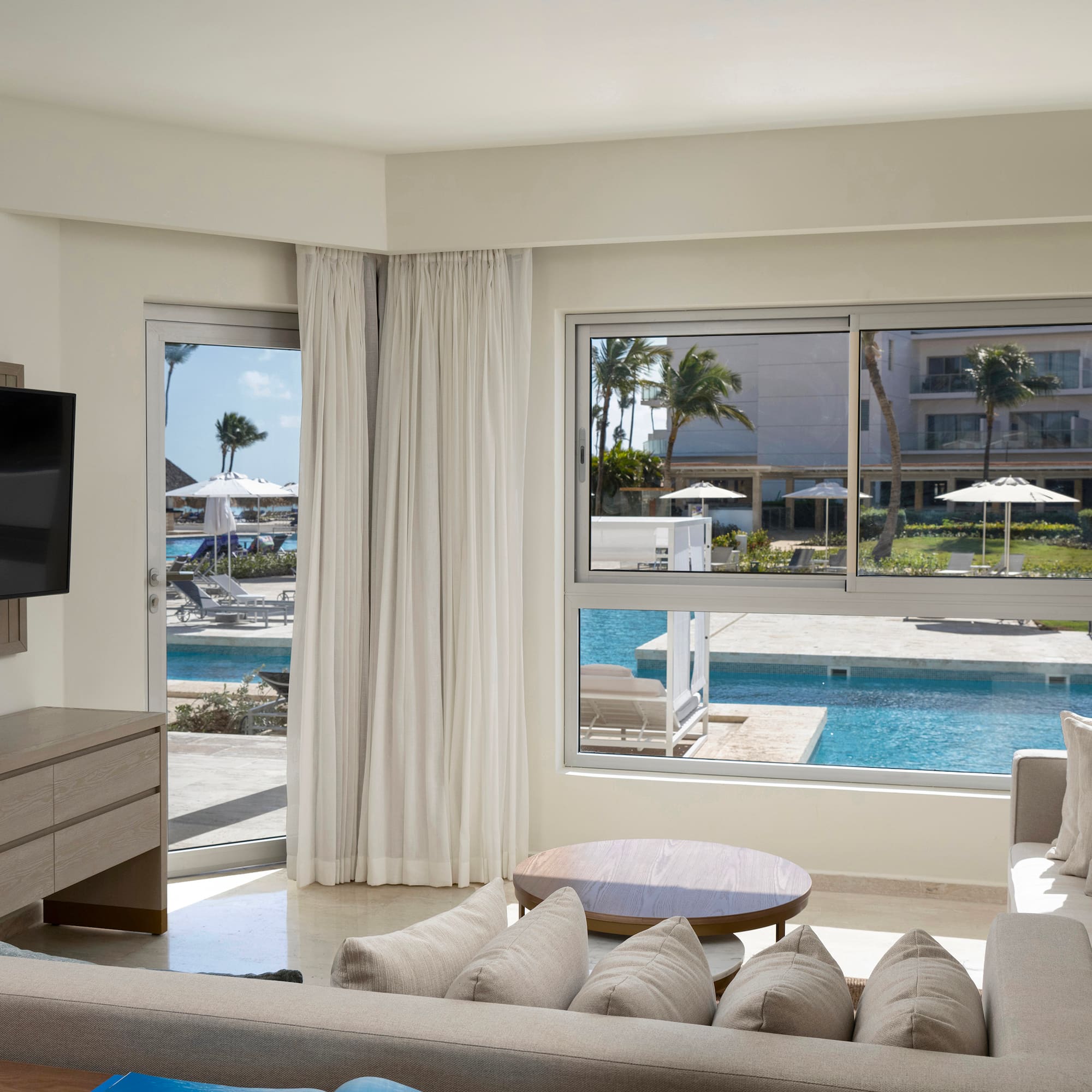 a living room with a television and a pool