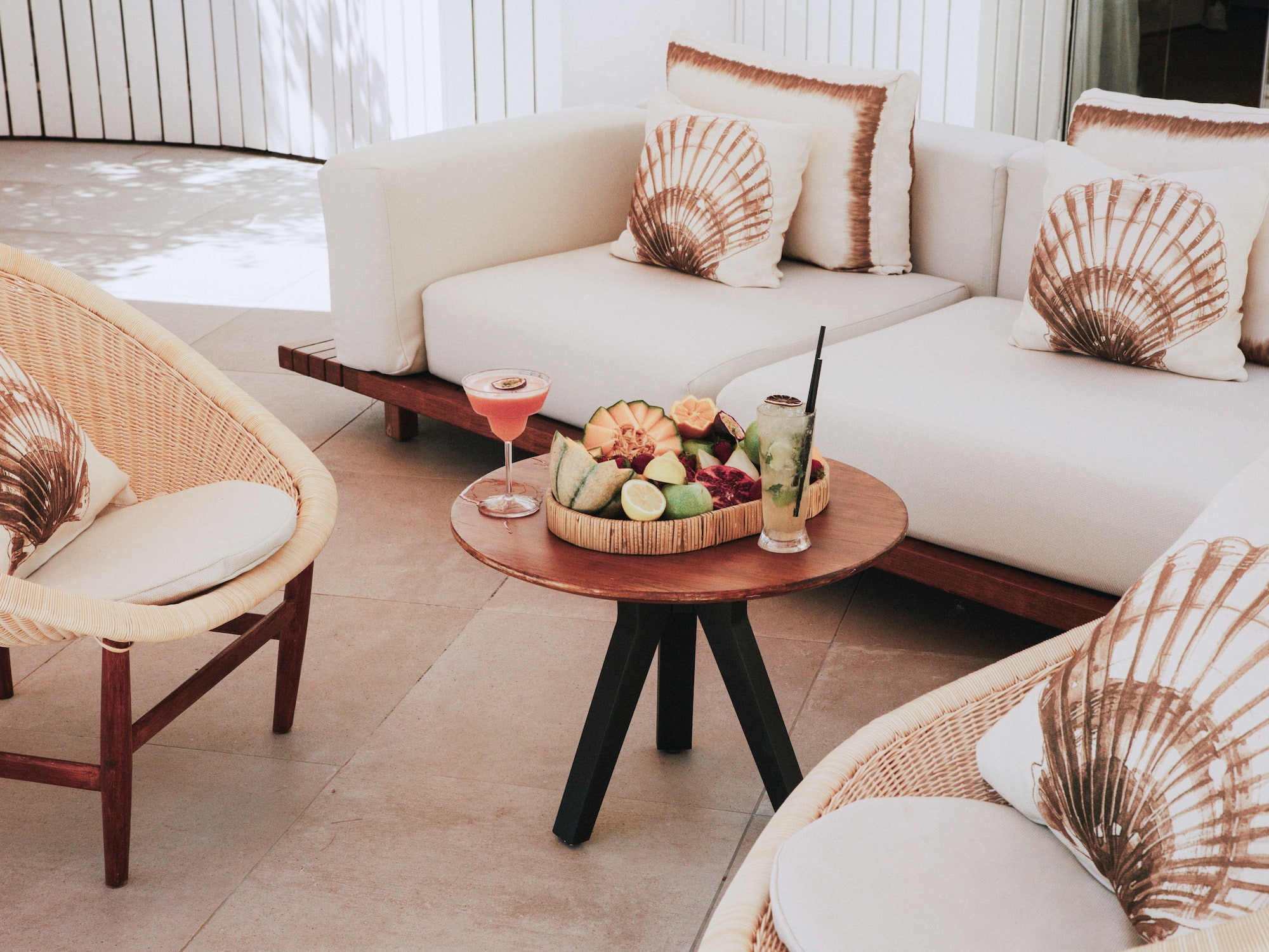 a table with fruit on it and a glass of drink on it