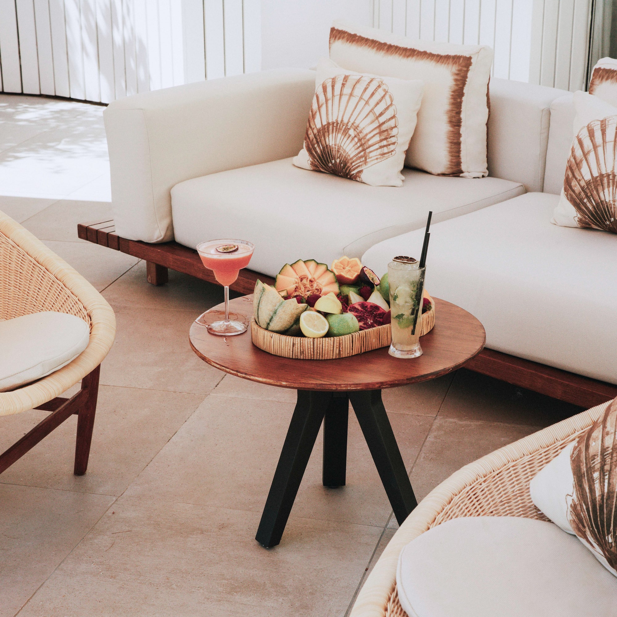 a table with fruit on it and a glass of drink on it