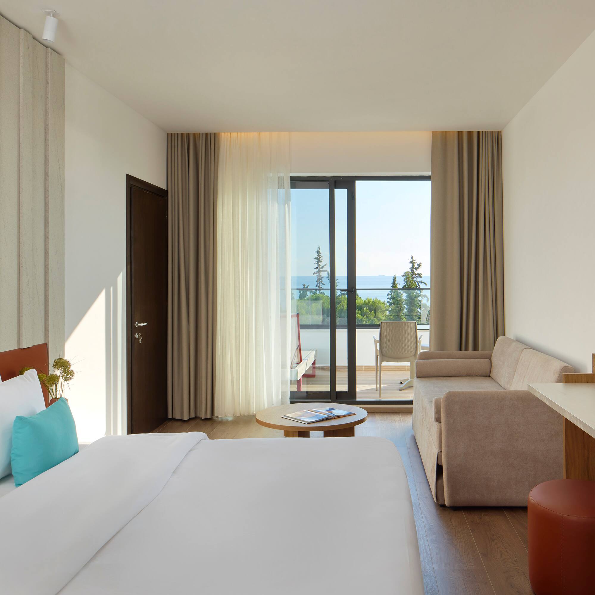 a room with a bed and couches