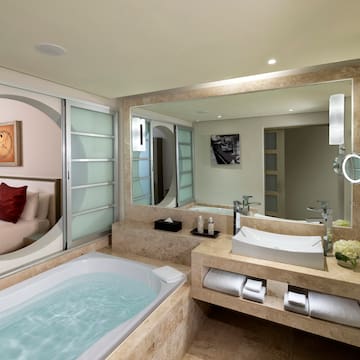 a bathroom with a bathtub and a mirror