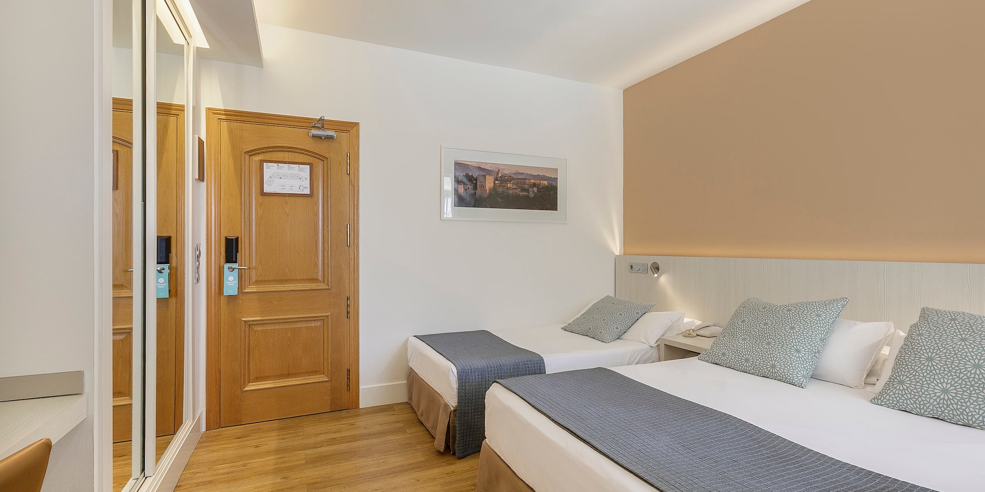 a room with two beds and a door