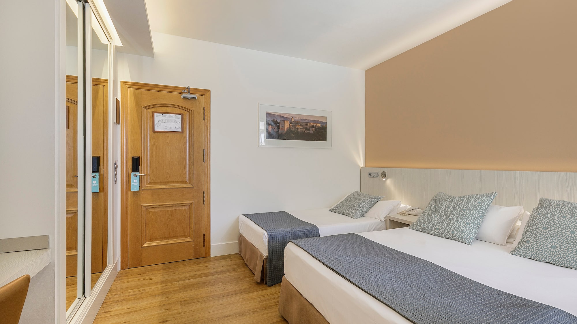 a room with two beds and a door