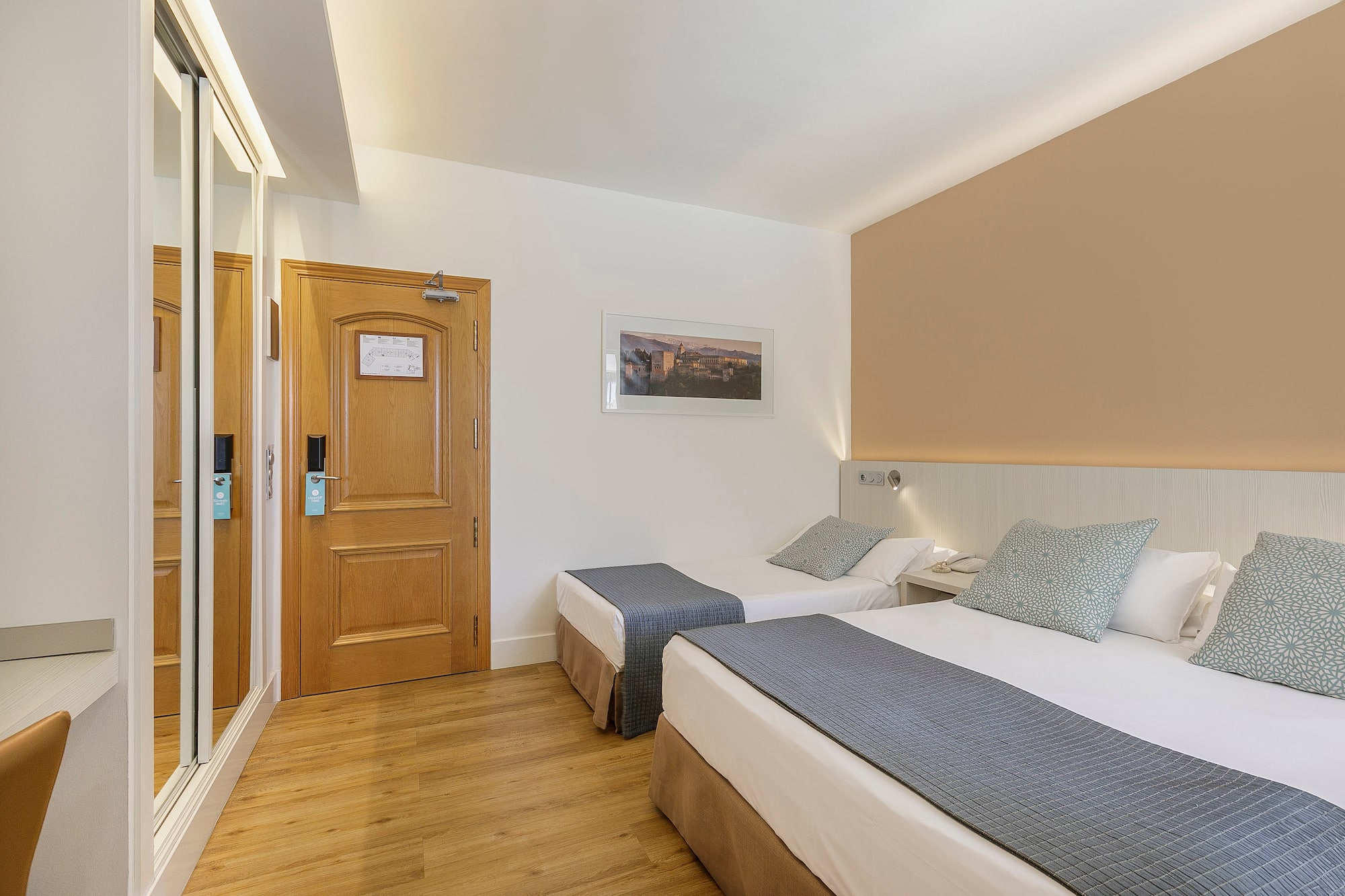 a room with two beds and a door